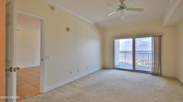 spare room featuring crown molding, light colored carpet, and ceiling fan