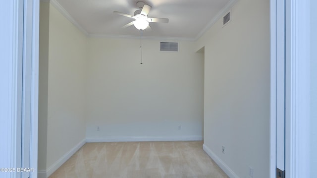 carpeted empty room featuring crown molding and ceiling fan