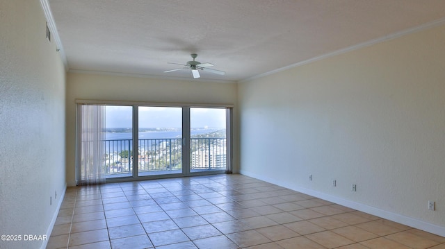 tiled spare room featuring crown molding, a water view, and ceiling fan