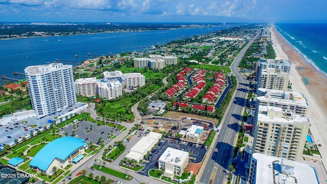 aerial view with a water view and a beach view