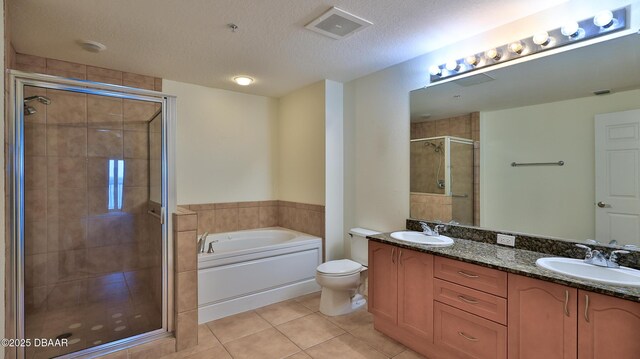 full bathroom with independent shower and bath, vanity, toilet, tile patterned floors, and a textured ceiling