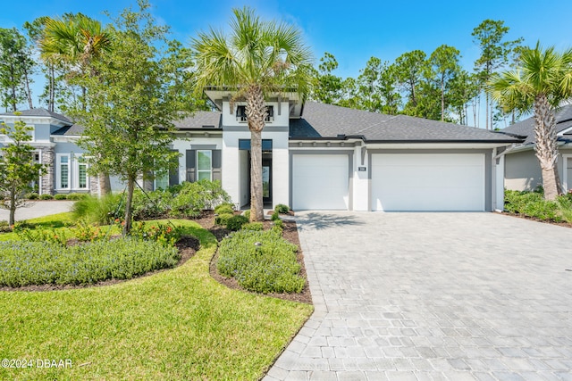 view of front facade featuring a garage and a front lawn