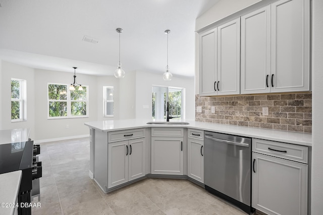 30 Peppercorn Ln, Palm Coast, FL 32164 - kitchen with stainless steel dishwasher, a peninsula, light countertops, and healthy amount of natural light