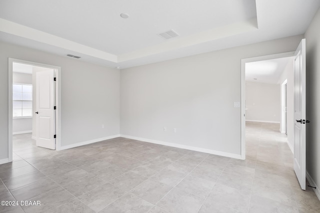30 Peppercorn Ln, Palm Coast, FL 32164 - unfurnished room featuring a raised ceiling, baseboards, and light tile patterned flooring