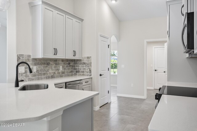 30 Peppercorn Ln, Palm Coast, FL 32164 - kitchen with black appliances, a sink, light countertops, and decorative backsplash