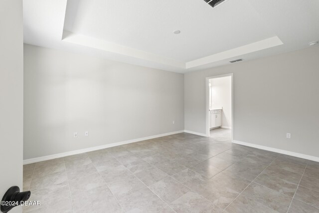 30 Peppercorn Ln, Palm Coast, FL 32164 - tiled empty room with a raised ceiling and baseboards