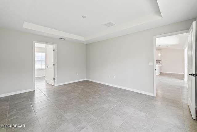 30 Peppercorn Ln, Palm Coast, FL 32164 - unfurnished room with a tray ceiling, light tile patterned flooring, and baseboards
