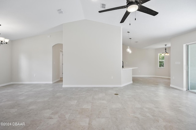 30 Peppercorn Ln, Palm Coast, FL 32164 - unfurnished living room with arched walkways, a ceiling fan, a chandelier, vaulted ceiling, and baseboards