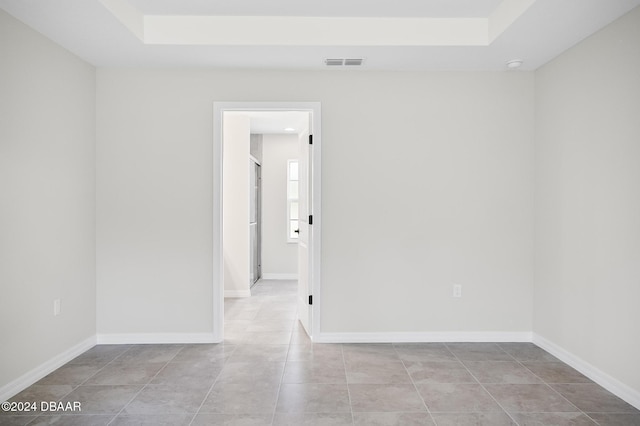 30 Peppercorn Ln, Palm Coast, FL 32164 - spare room with a raised ceiling, tile patterned flooring, and baseboards