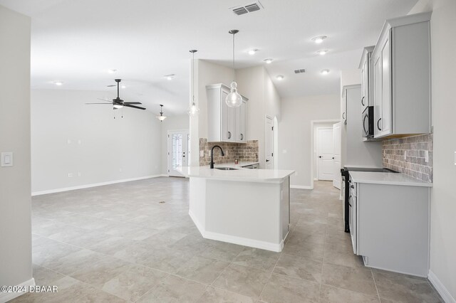 30 Peppercorn Ln, Palm Coast, FL 32164 - kitchen with a sink, stainless steel appliances, backsplash, lofted ceiling, and a ceiling fan