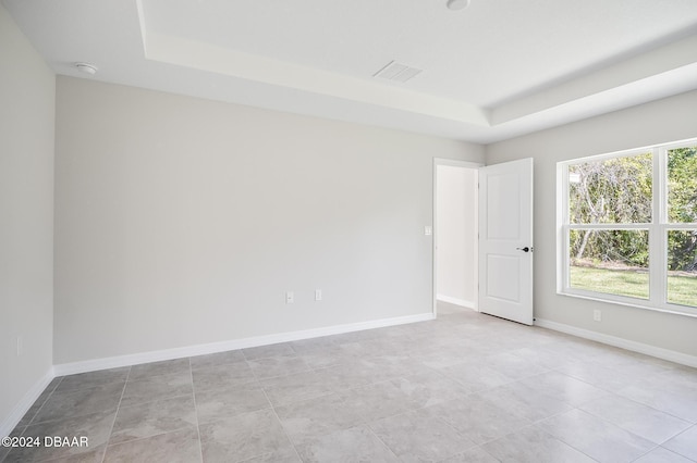 30 Peppercorn Ln, Palm Coast, FL 32164 - unfurnished room with a raised ceiling, a smoke detector, baseboards, and light tile patterned floors