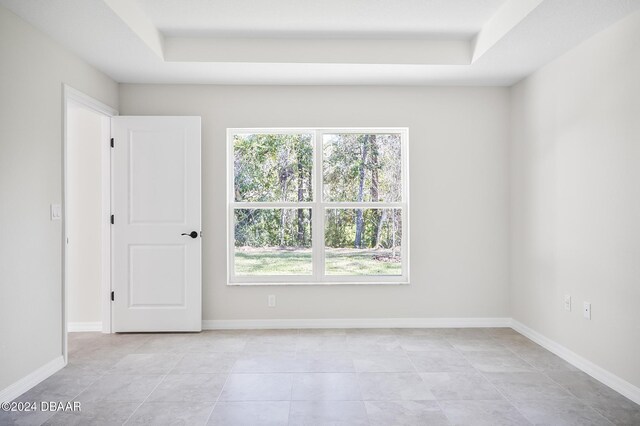 30 Peppercorn Ln, Palm Coast, FL 32164 - unfurnished room with healthy amount of natural light, a raised ceiling, and light tile patterned flooring