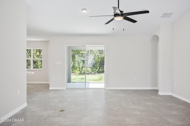 30 Peppercorn Ln, Palm Coast, FL 32164 - unfurnished room with ceiling fan, light tile patterned floors, arched walkways, and baseboards