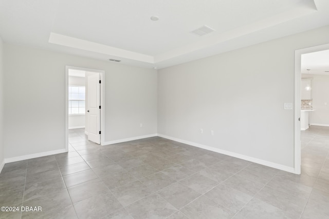 30 Peppercorn Ln, Palm Coast, FL 32164 - unfurnished room with a tray ceiling, light tile patterned floors, and baseboards