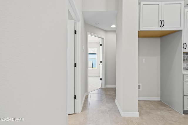 30 Peppercorn Ln, Palm Coast, FL 32164 - hallway with light tile patterned floors and baseboards
