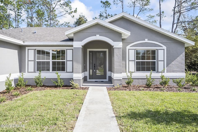 30 Peppercorn Ln, Palm Coast, FL 32164 - view of front of house with a front lawn and roof with shingles