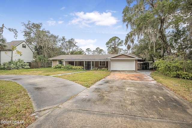 ranch-style house featuring a garage and a front lawn