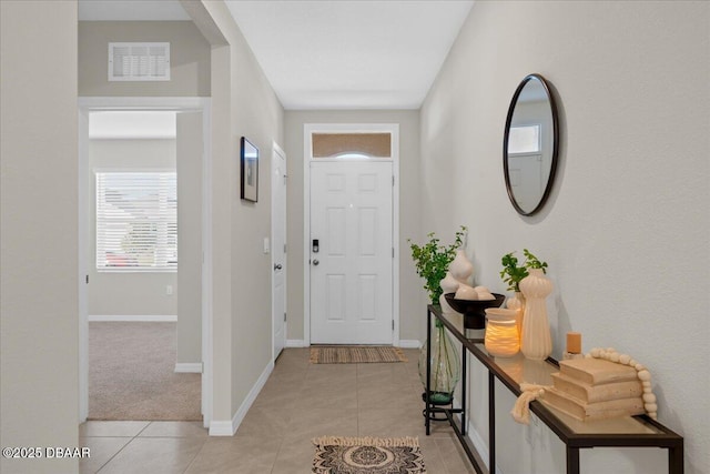 foyer featuring light tile patterned floors