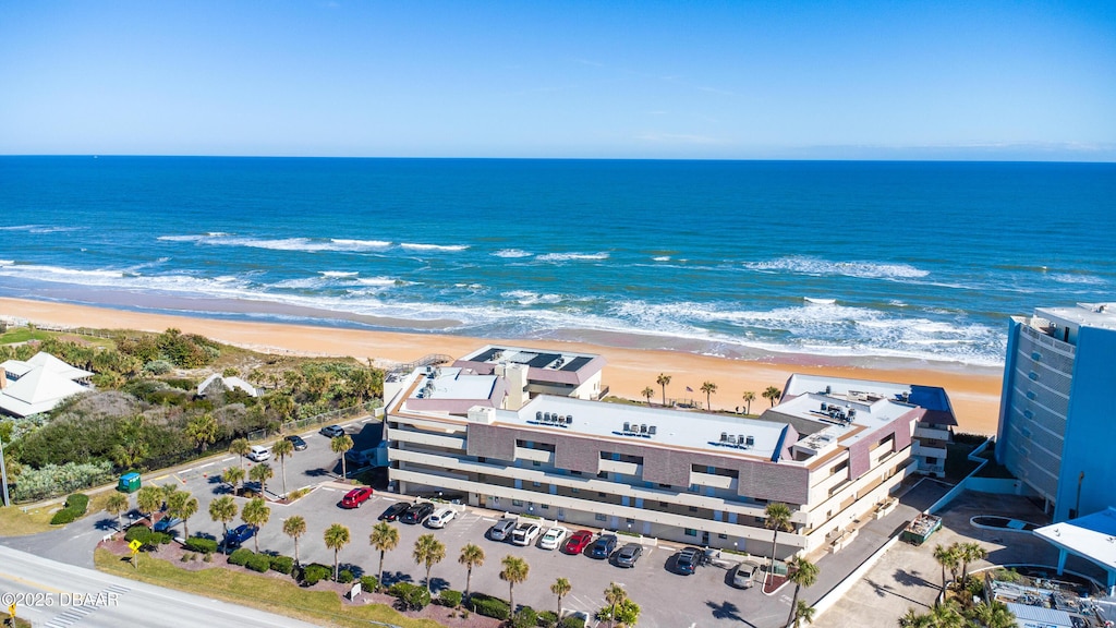 birds eye view of property with a beach view and a water view