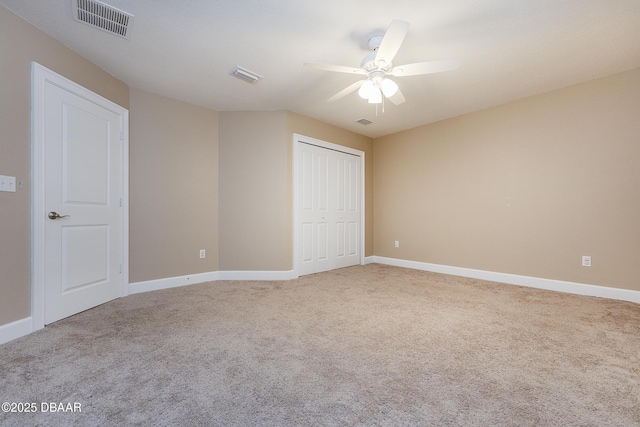 unfurnished bedroom featuring visible vents, carpet, and baseboards