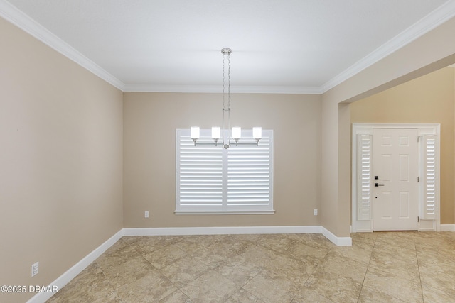spare room with baseboards, ornamental molding, and a chandelier