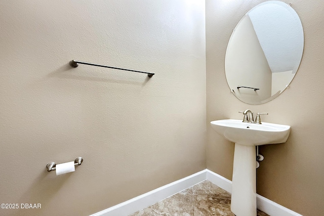 bathroom with tile patterned flooring and baseboards