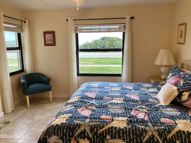 tiled bedroom featuring multiple windows