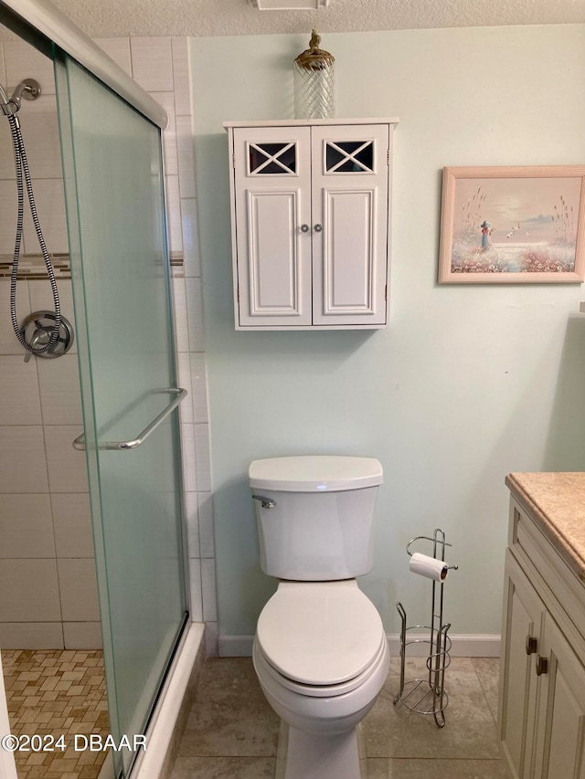 bathroom with vanity, a textured ceiling, and tile patterned flooring