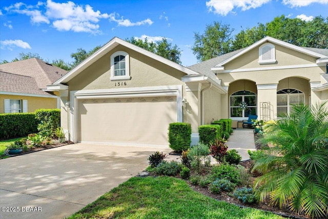 1316 Asher Ct, Ormond Beach, FL 32174 - view of front of property featuring stucco siding, a garage, and driveway