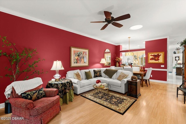 1316 Asher Ct, Ormond Beach, FL 32174 - living area featuring ceiling fan, wood finished floors, crown molding, baseboards, and an accent wall