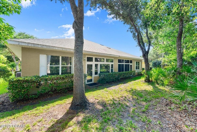 1316 Asher Ct, Ormond Beach, FL 32174 - back of house featuring stucco siding, central air condition unit, and roof with shingles