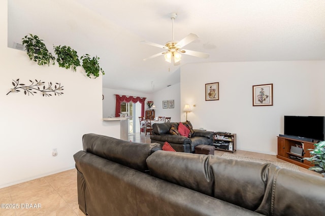 living room featuring light tile patterned floors, baseboards, a ceiling fan, and vaulted ceiling