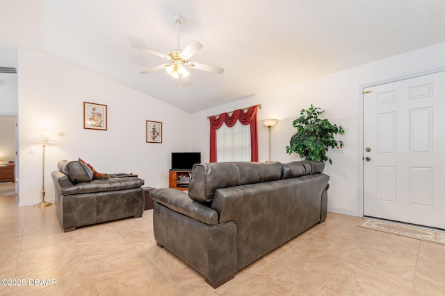 living room with light tile patterned floors, ceiling fan, baseboards, and lofted ceiling