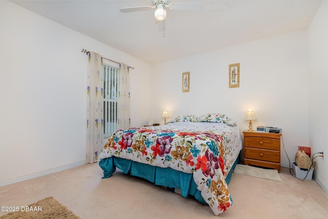 carpeted bedroom featuring baseboards, a ceiling fan, and access to outside