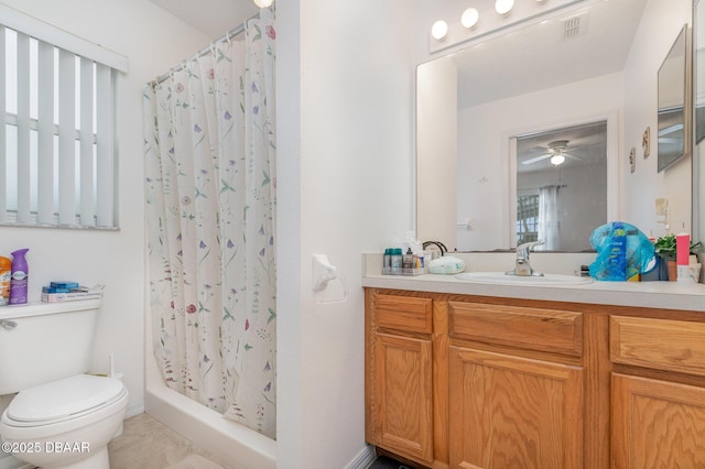 full bathroom featuring visible vents, a shower stall, toilet, vanity, and a ceiling fan