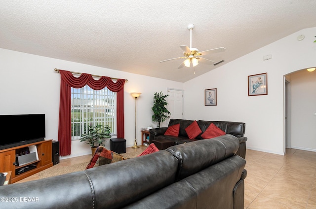 living room featuring visible vents, vaulted ceiling, arched walkways, a textured ceiling, and a ceiling fan