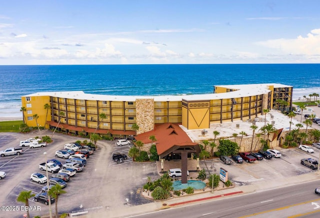 bird's eye view featuring a water view and a beach view