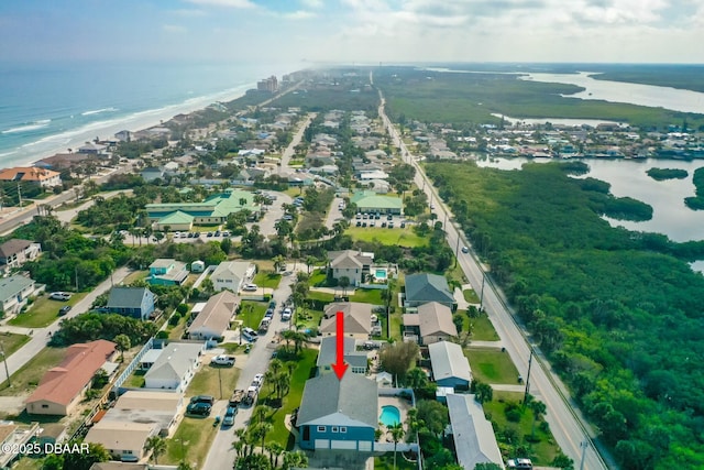 birds eye view of property featuring a water view and a view of the beach