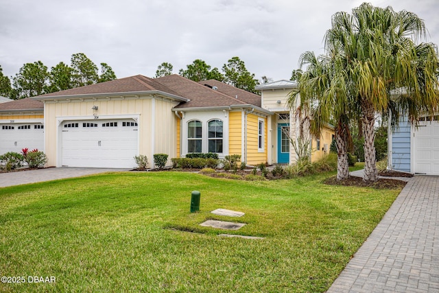 view of front of house featuring a garage and a front lawn