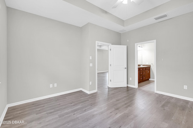 304 Coral Reef Way, Daytona Beach, FL 32124 - unfurnished bedroom with a ceiling fan, visible vents, wood finished floors, baseboards, and ensuite bath