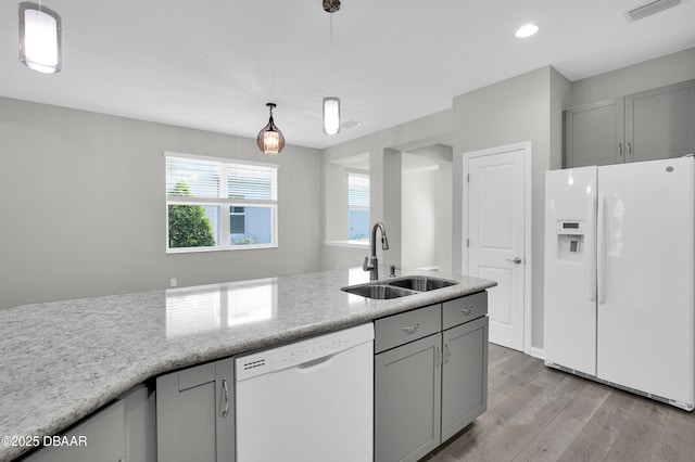 304 Coral Reef Way, Daytona Beach, FL 32124 - kitchen with visible vents, white appliances, light wood-type flooring, gray cabinets, and a sink