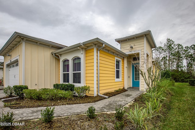 304 Coral Reef Way, Daytona Beach, FL 32124 - view of front of house featuring board and batten siding and a garage