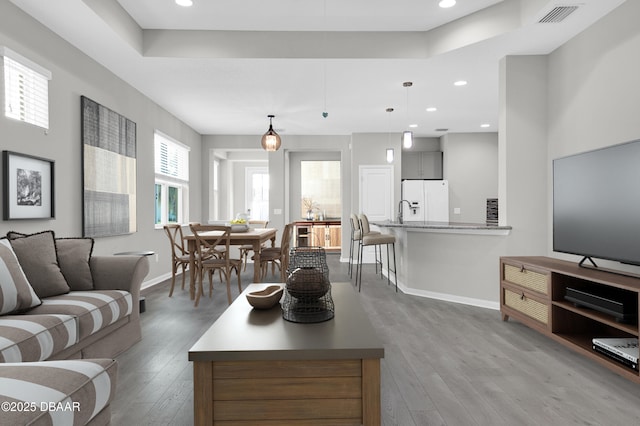 304 Coral Reef Way, Daytona Beach, FL 32124 - living room featuring baseboards, recessed lighting, wood finished floors, and visible vents