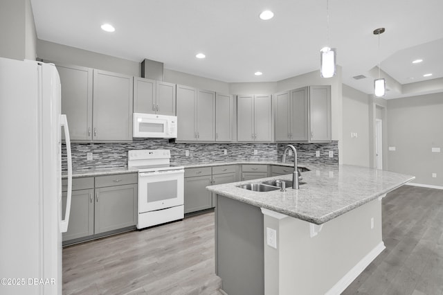 304 Coral Reef Way, Daytona Beach, FL 32124 - kitchen with white appliances, gray cabinets, a sink, and light wood finished floors
