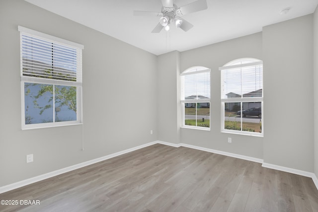 304 Coral Reef Way, Daytona Beach, FL 32124 - empty room with baseboards, ceiling fan, a healthy amount of sunlight, and wood finished floors