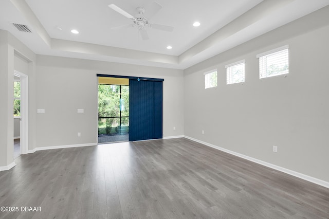 304 Coral Reef Way, Daytona Beach, FL 32124 - spare room featuring a raised ceiling, plenty of natural light, wood finished floors, and visible vents