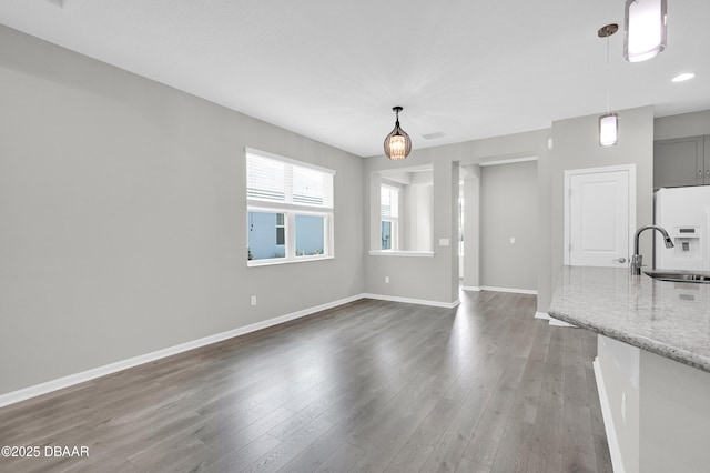 304 Coral Reef Way, Daytona Beach, FL 32124 - unfurnished living room featuring recessed lighting, baseboards, a sink, and wood finished floors
