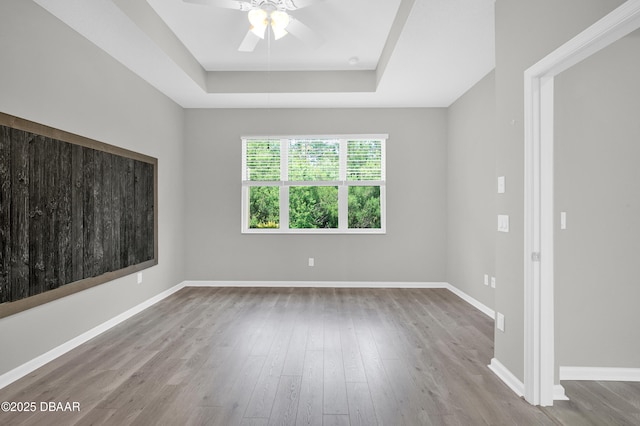 304 Coral Reef Way, Daytona Beach, FL 32124 - unfurnished room featuring a ceiling fan, baseboards, wood finished floors, and a raised ceiling