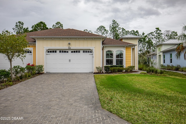 304 Coral Reef Way, Daytona Beach, FL 32124 - view of front of property with roof with shingles, decorative driveway, a front yard, and a garage