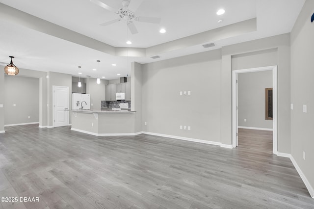 304 Coral Reef Way, Daytona Beach, FL 32124 - unfurnished living room with visible vents, baseboards, recessed lighting, a ceiling fan, and light wood-style flooring